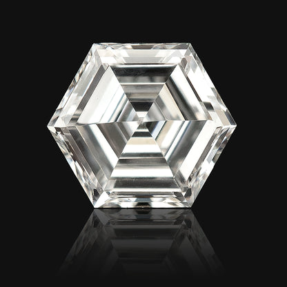 Digitally isolated close-up of a hexagonal step-cut diamond on black, with a decorative reflection beneath it.