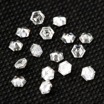 Alternate arrangement of loose hexagonal diamonds on black fabric, with mixed orientations and varied reflections.