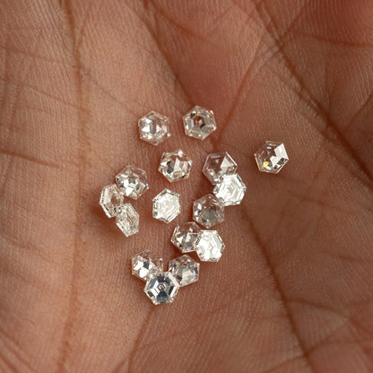 Closer view of the hexagonal diamond group resting in a palm, showing outlines at different angles.