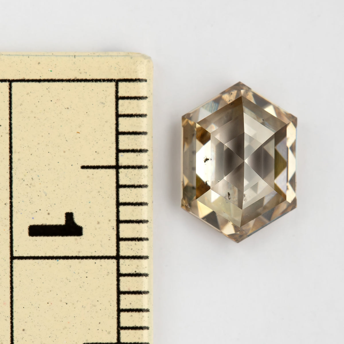 Ruler-scale view of the approximately 9 mm long diamond. IGI-HEXA-5924-0195CT.