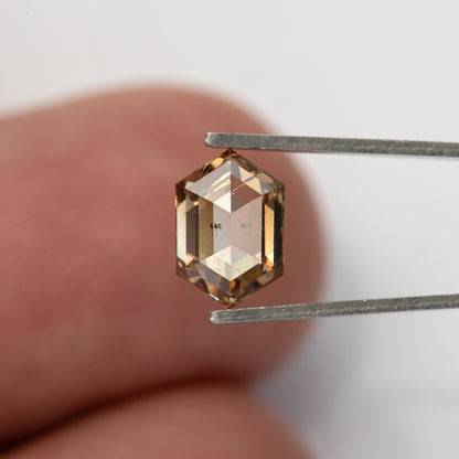 Reverse tweezers view against fingers for scale. IGI-HEXA-5925-0110CT.
