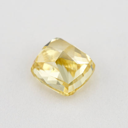 Low side view of the yellow cushion-shaped natural diamond, showing the crown, girdle and pavilion facets.