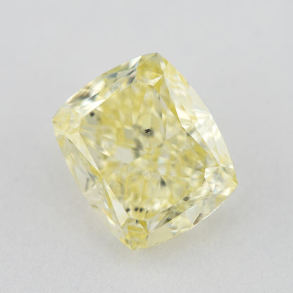 Alternate angled face-up view of the yellow cushion diamond on a pale background, with a different pattern of light and dark facet reflections.