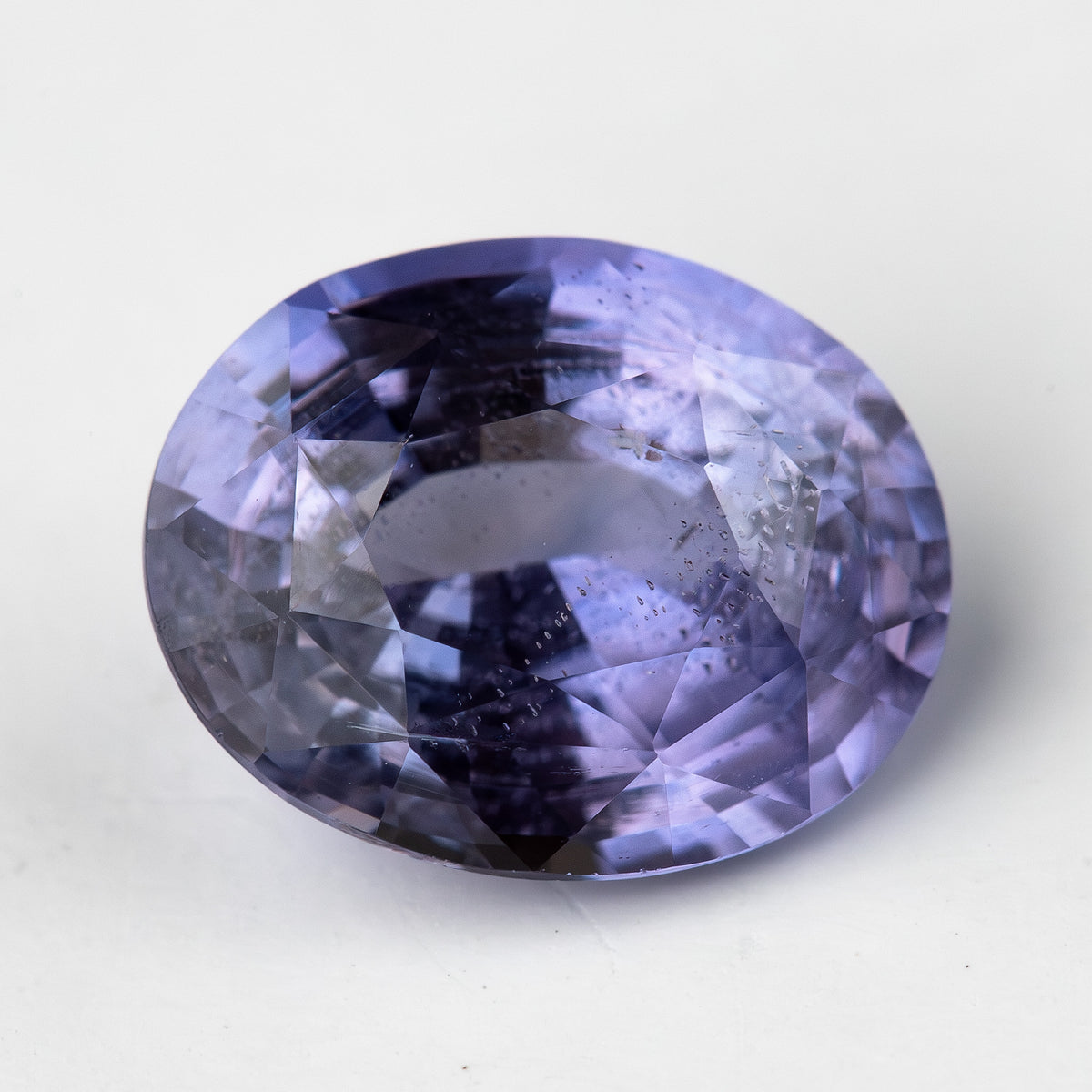 Lavender-blue oval sapphire with visible inclusions viewed face-up. View 7.