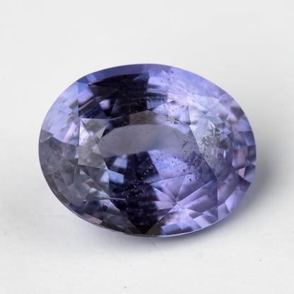 Lavender-blue oval sapphire with visible inclusions viewed face-up. View 7.