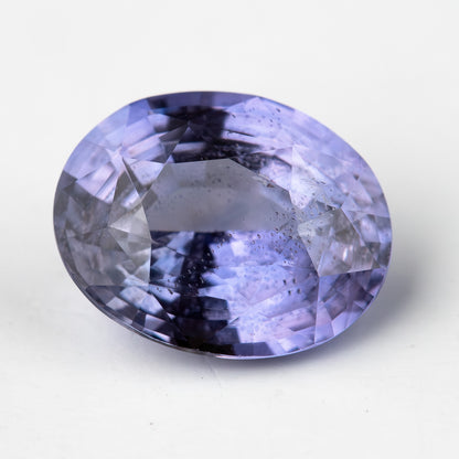 Lavender-blue oval sapphire with visible inclusions viewed face-up. View 8.