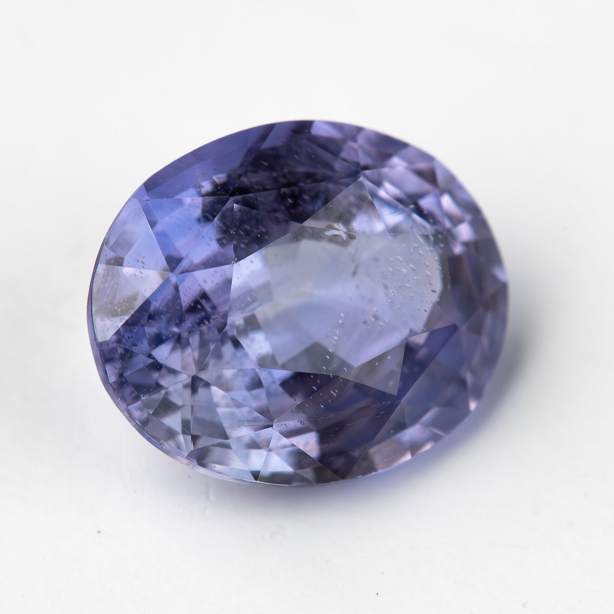 Lavender-blue oval sapphire with visible inclusions viewed face-up. View 10.