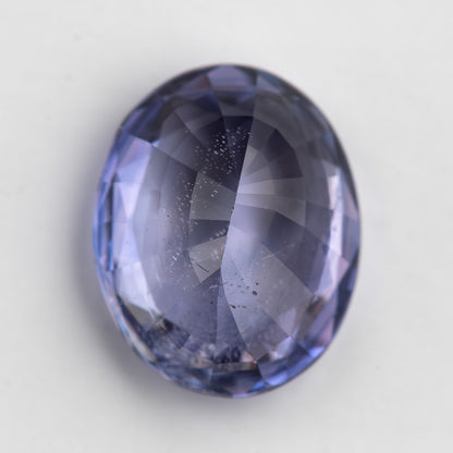 Lavender-blue oval sapphire with visible inclusions viewed from the pavilion side. View 18.