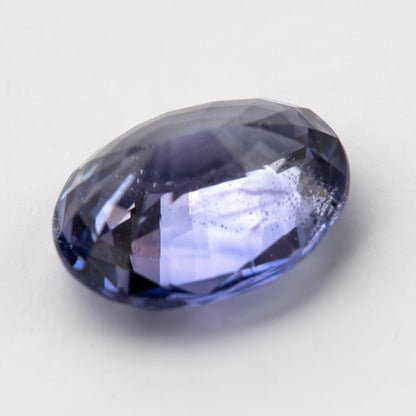 Lavender-blue oval sapphire with visible inclusions viewed from the side, showing crown and pavilion depth. View 13.