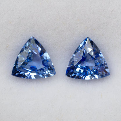 Two blue trillion-cut gemstones showing facet details.