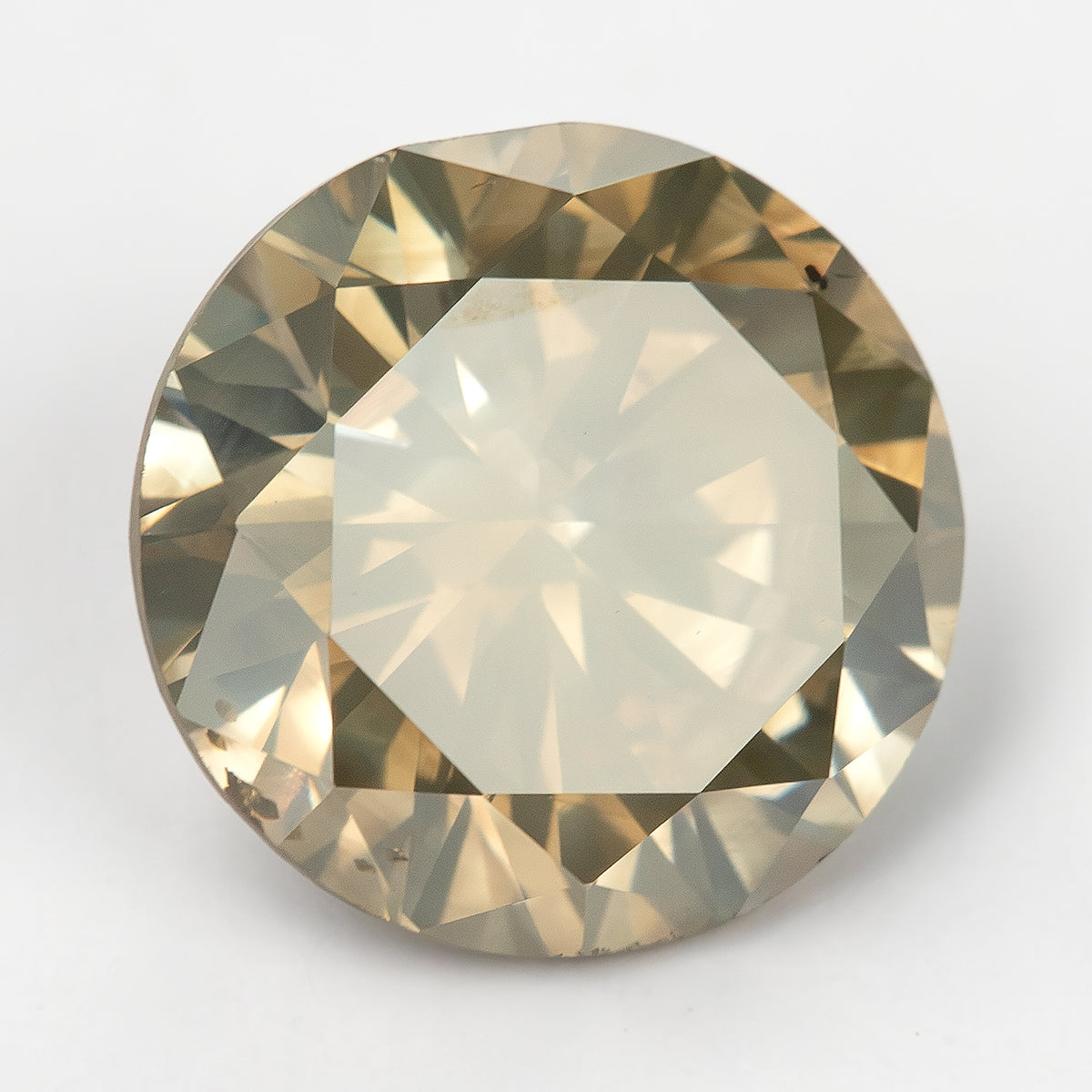 Another face-up angle of KL444, with a bright table reflection and alternating light and dark facets near the edge.
