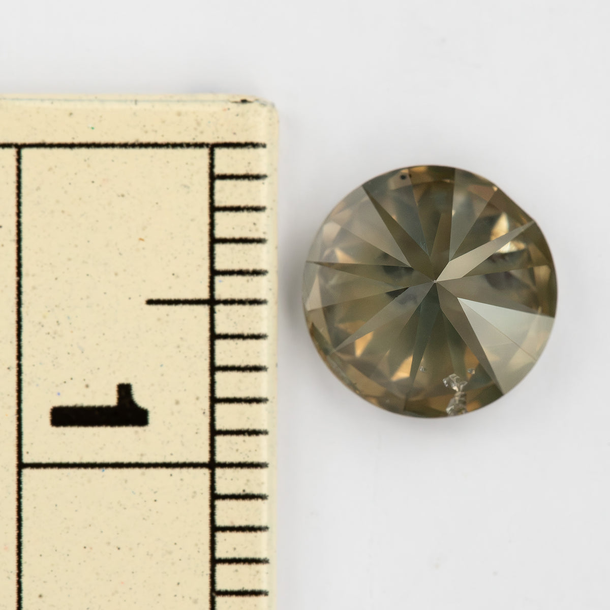 KL444 round natural diamond beside a ruler for scale; the stone's measured diameter is 7.87-7.97 mm.