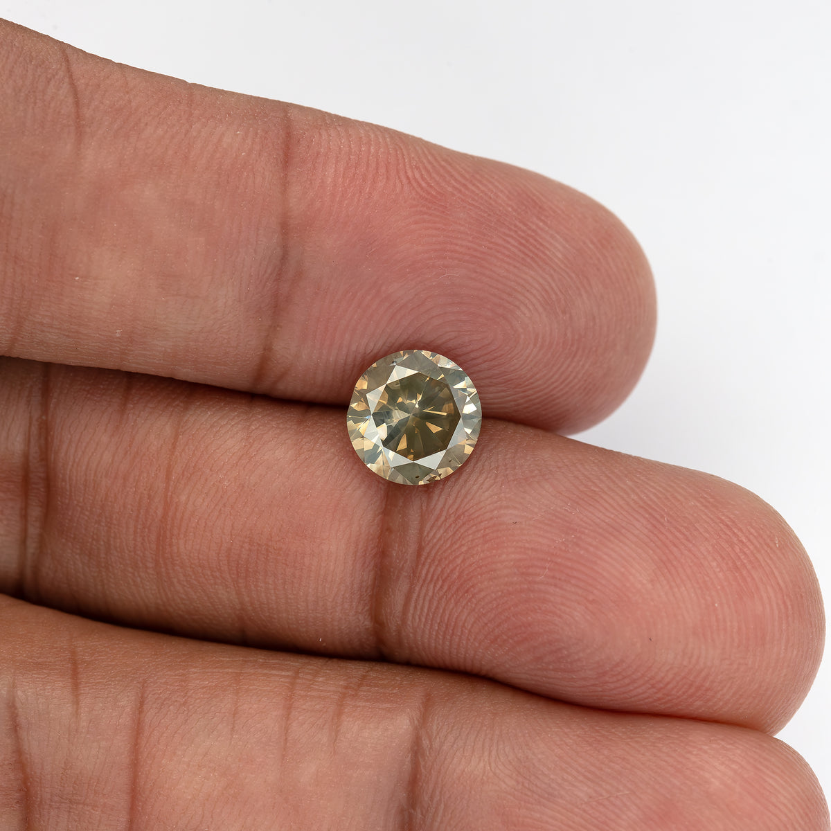 Wider view of KL444 resting on the fingers, providing hand-scale context for the 2.00 carat round diamond.