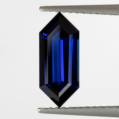 Upright angled tweezers view showing blue parallel reflections within dark border facets.
