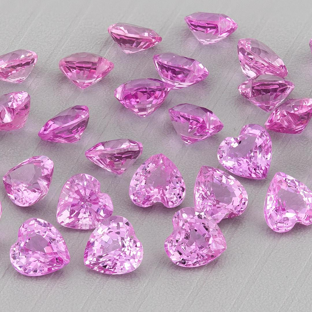 Representative pink heart sapphire parcel at an oblique angle, with heart outlines, crown facets and deeper side profiles visible.