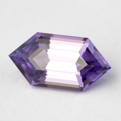 Zafiro violeta púrpura inclinado sobre blanco con un amplio reflejo brillante a través de la tabla central.