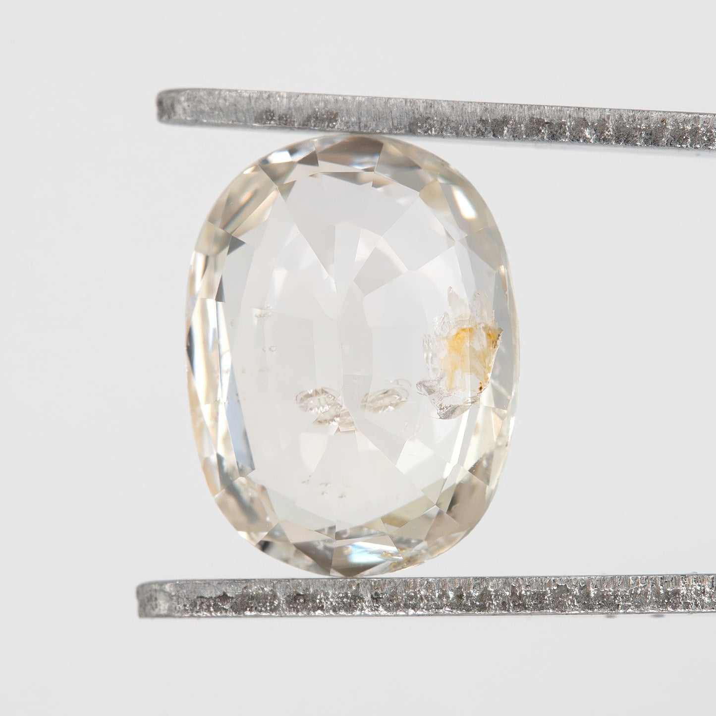 Champagne Cream | 1.74 Carat Oval Cut Heated Natural Sapphire with Rustic Eye Inclusions for Custom Jewelry Design