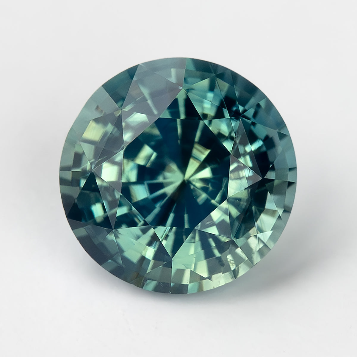 Teal blue-green round step-cut sapphire viewed face-up. View 7.