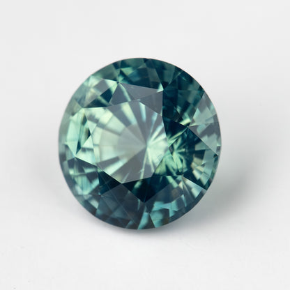 Teal blue-green round step-cut sapphire viewed face-up. View 8.