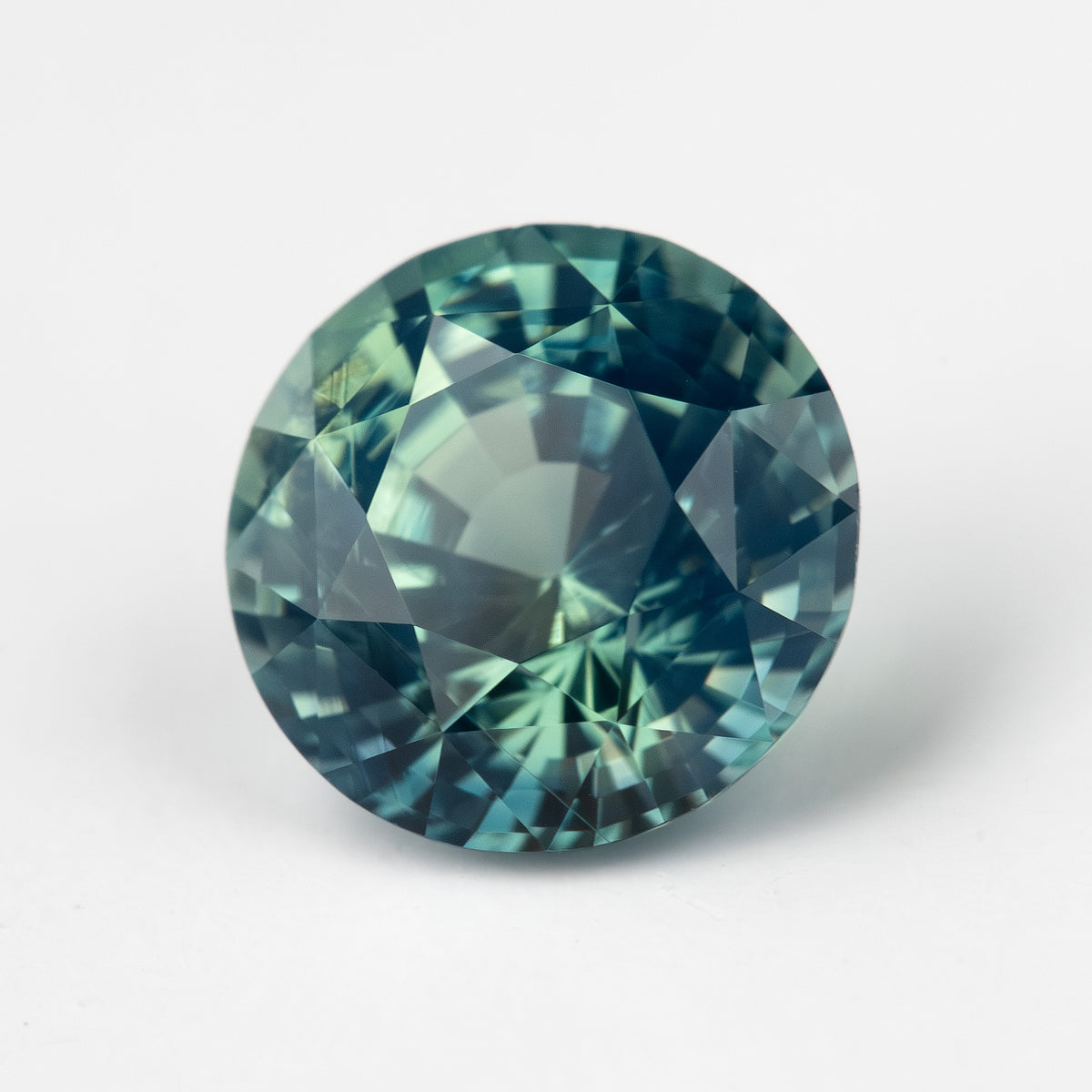 Teal blue-green round step-cut sapphire viewed face-up. View 9.