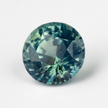 Teal blue-green round step-cut sapphire viewed face-up. View 9.
