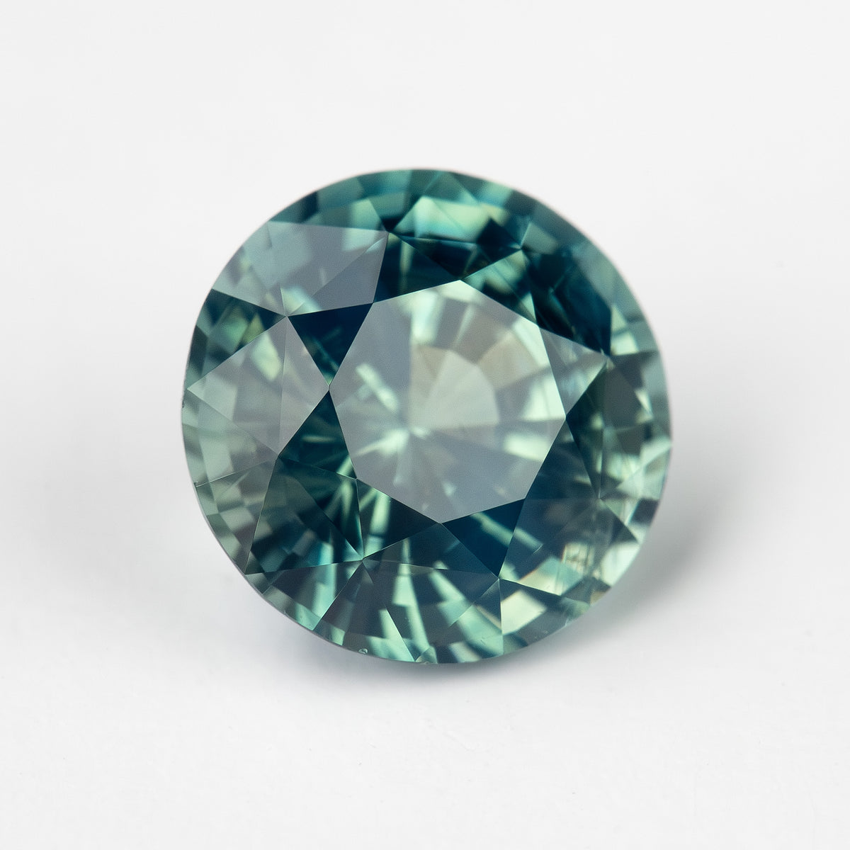 Teal blue-green round step-cut sapphire viewed face-up. View 18.