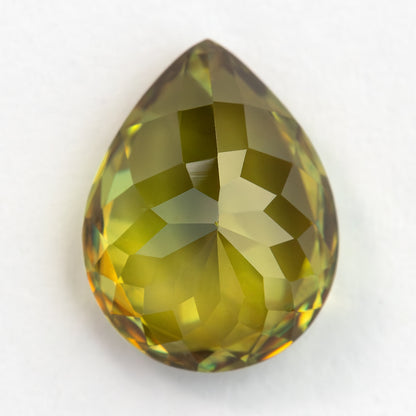 Pear-shaped sphene viewed from the pavilion side on white, showing large pale green-yellow facets.