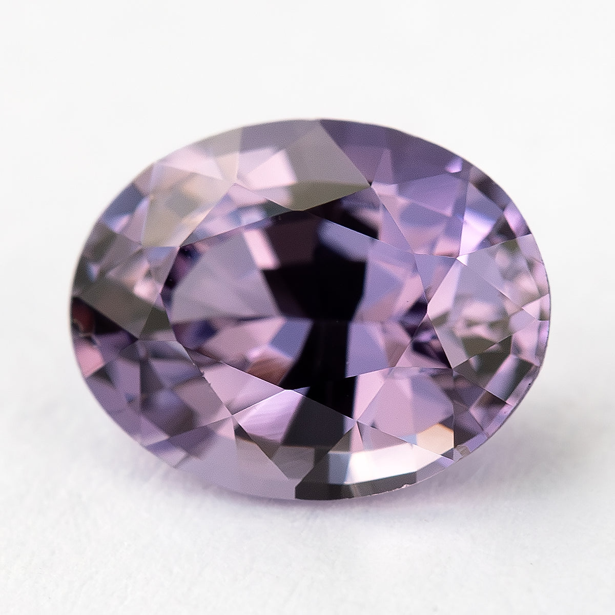 Tilted face-up view of oval spinel showing its mixed-cut facets.