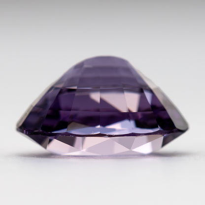 Angled side view of spinel showing pavilion facets and depth.