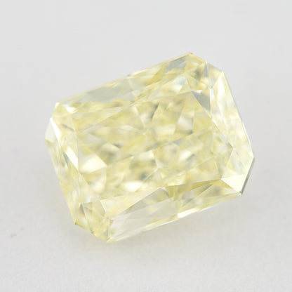 Tilted crown view of the pale yellow rectangular radiant-cut natural diamond, showing a different pattern of bright and dark facet reflections.