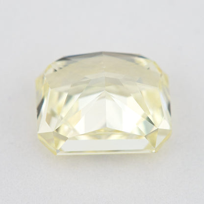 Low side view of the pale yellow rectangular radiant-cut natural diamond, showing the crown, girdle and pavilion facets.