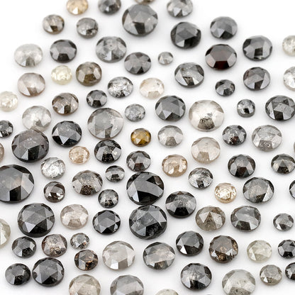 Assorted round rose-cut diamonds in pale grey, dark grey and black on white; this shows the source parcel, not a promised individual scoop.