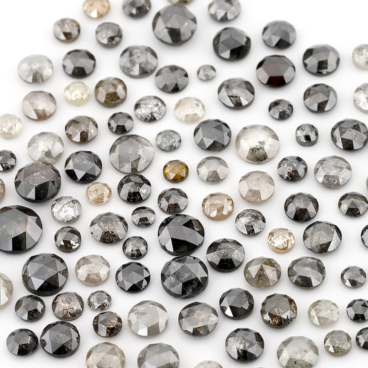 Assorted round rose-cut diamonds in pale grey, dark grey and black on white; this shows the source parcel, not a promised individual scoop.