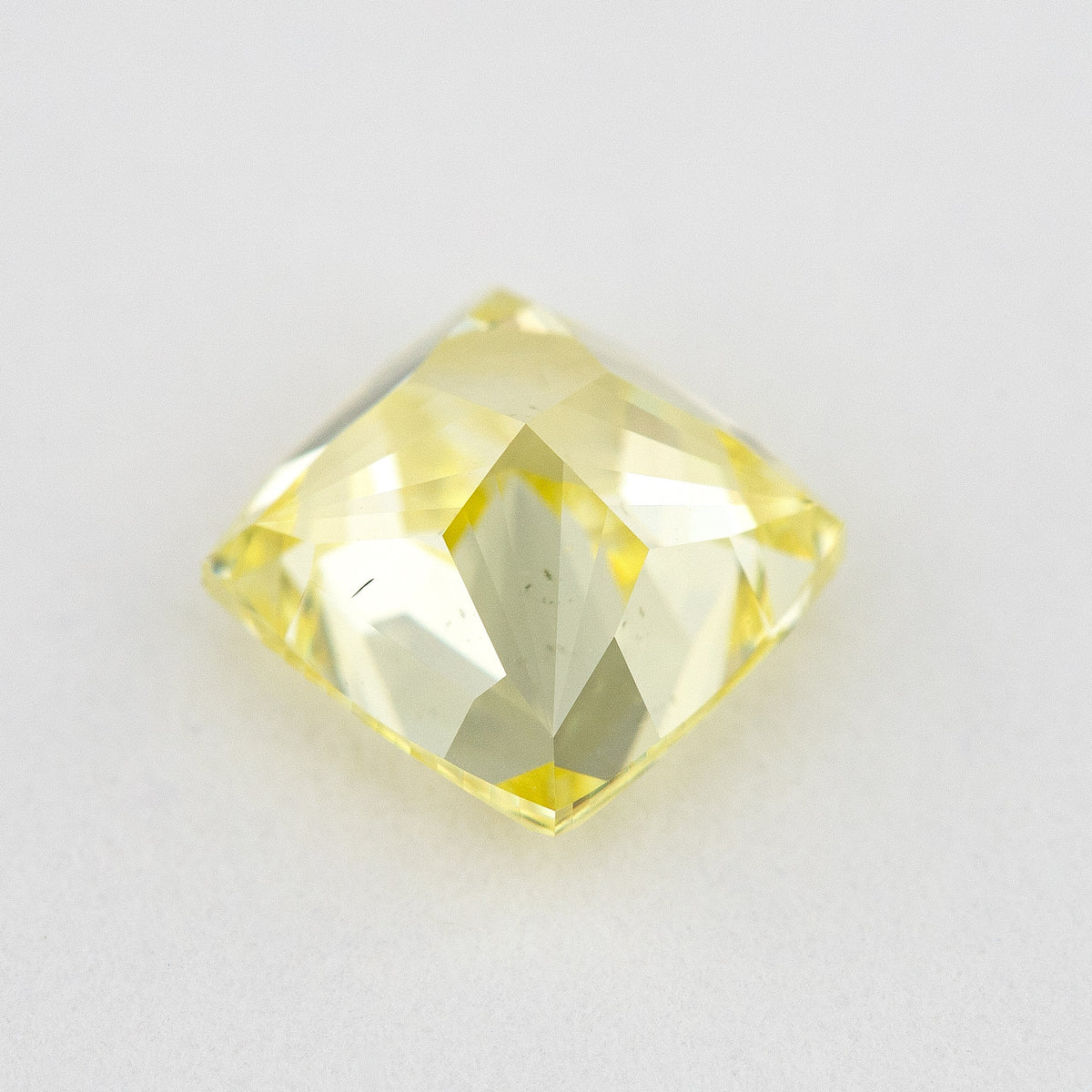 Pavilion and back view of the cushion-shaped yellow diamond, showing broad rear facets and its outline.