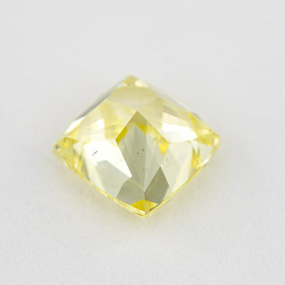 Pavilion and back view of the cushion-shaped yellow diamond, showing broad rear facets and its outline.