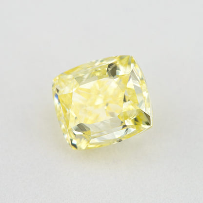 Cushion-shaped yellow diamond tilted on a pale background, showing a different facet reflection.