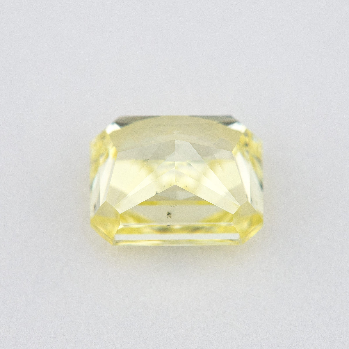 Pavilion and back view of the radiant-cut yellow diamond, showing broad rear facets and its cut-cornered outline.