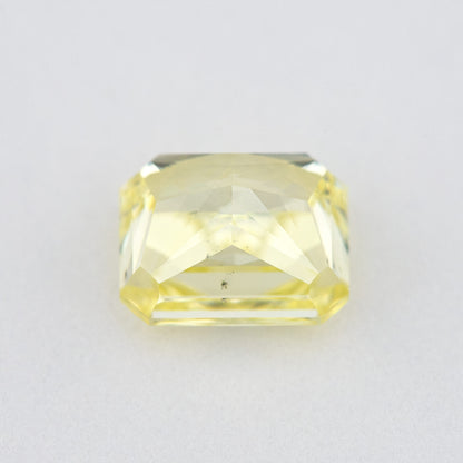 Pavilion and back view of the radiant-cut yellow diamond, showing broad rear facets and its cut-cornered outline.