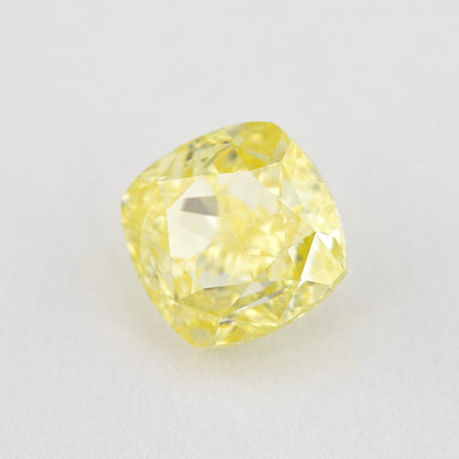 Alternate crown-side view of the yellow cushion diamond, showing its table and facet reflections.