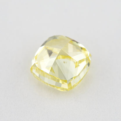 Back view of the yellow cushion diamond, showing the pavilion faceting and outline.
