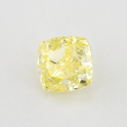 Angled crown view of the cushion-shaped yellow diamond, with a different pattern of bright and darker reflections.