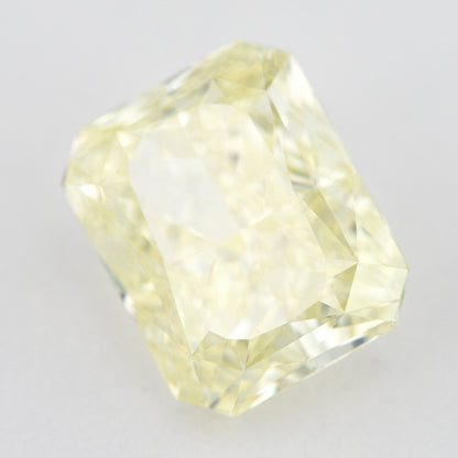 Tilted crown view of the pale yellow rectangular radiant-cut natural diamond, showing a different pattern of bright and dark facet reflections.