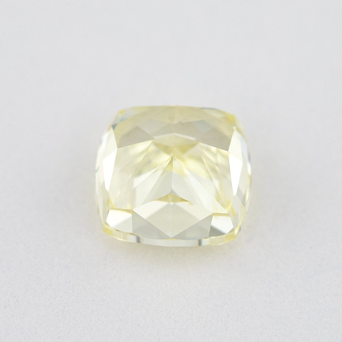 Pavilion and back view of the cushion-shaped yellow diamond, showing broad rear facets and its outline.