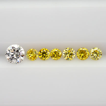 Close face-up row showing the six yellow diamonds and an excluded white comparison diamond.