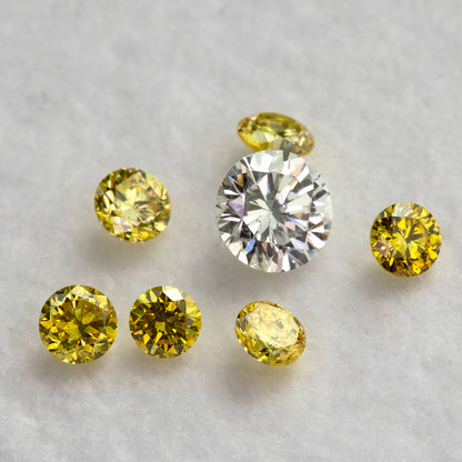 Tilted yellow diamonds with visible side facets around an excluded white comparison diamond.