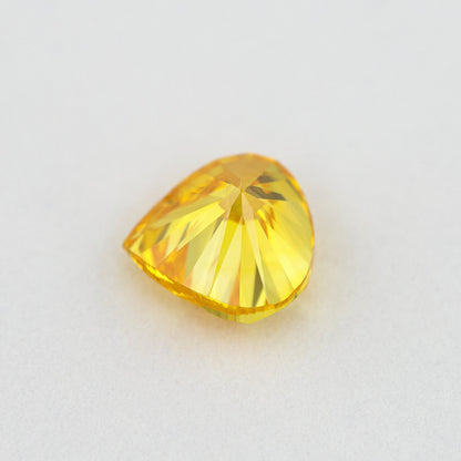 Back view of the yellow-orange heart-shaped diamond, showing the pavilion faceting and outline.