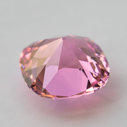 Pink cushion-shaped lab-grown YAG shown at an angle from the pavilion side. View 14.
