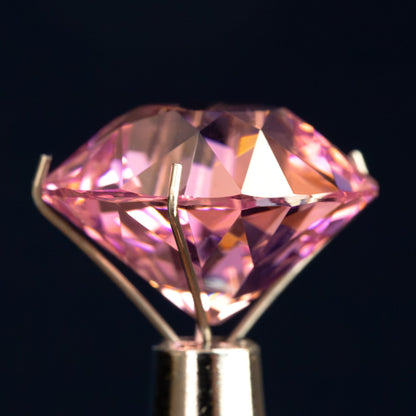 Pink cushion-shaped lab-grown YAG viewed from the side, showing crown and pavilion depth. View 11.