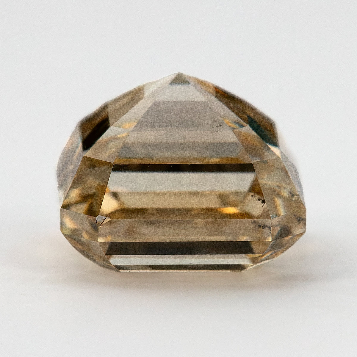 Full side profile of the square emerald-cut diamond showing crown height, girdle and stepped pavilion.
