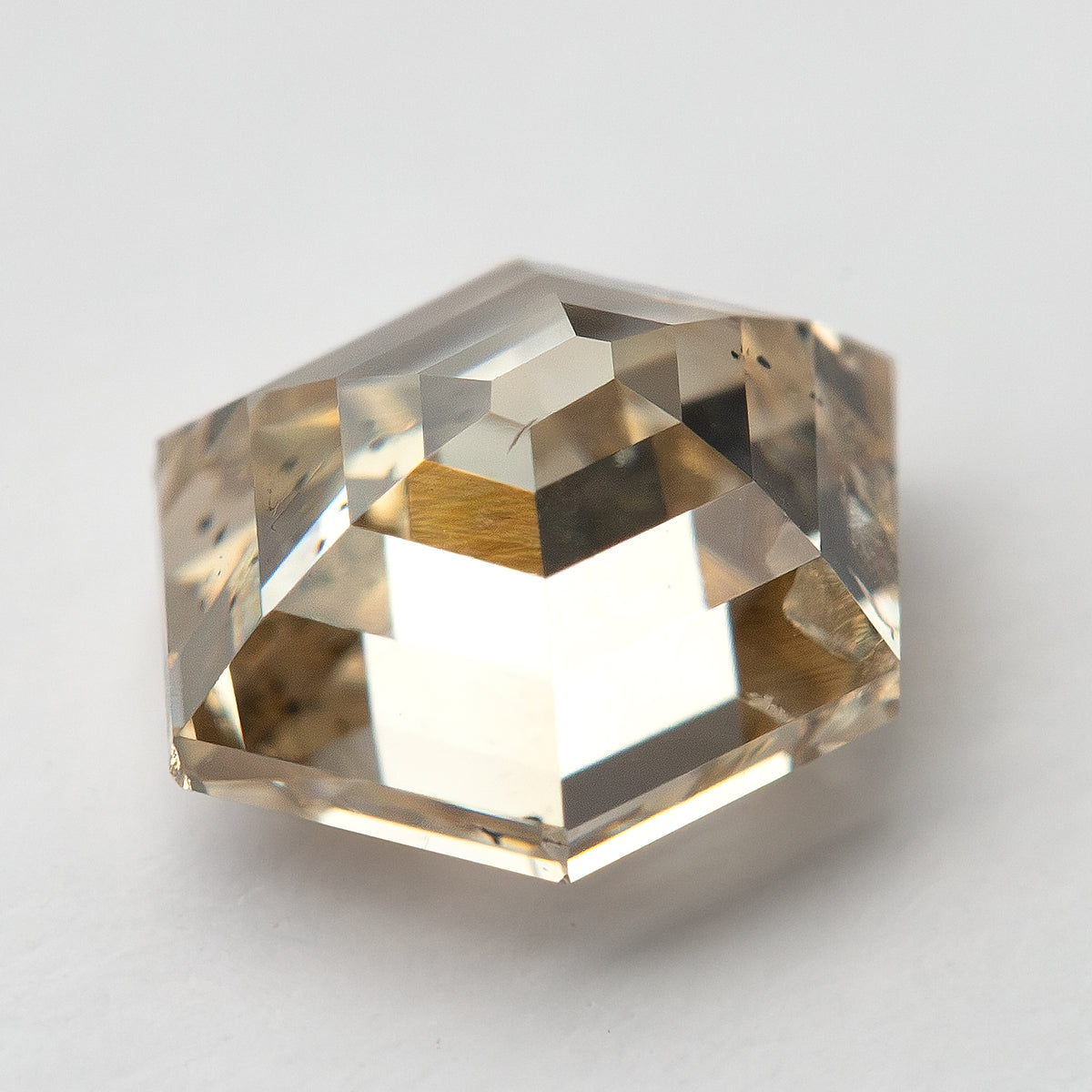 Angled side view of the champagne hexagon diamond and step facets